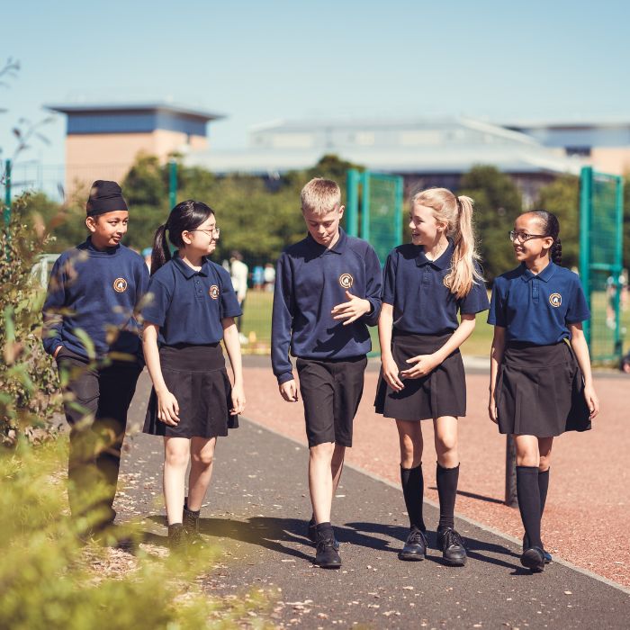 A group of students walking along the corridor. 